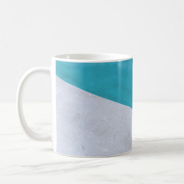 Empty grey floor beside pool coffee mug (Left)