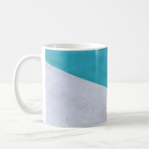 Empty grey floor beside pool coffee mug
