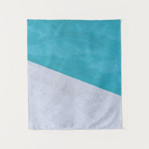 Empty grey floor beside pool tapestry