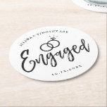Engagement Party Script Lettering | Round Paper Coaster<br><div class="desc">A fun and unique script lettered paper coaster tailored specifically to you an engagement party.  It features the word "engaged" with wedding rings resting over it. Underneath this and above it are the names of the bride and groom and the engagement date.</div>