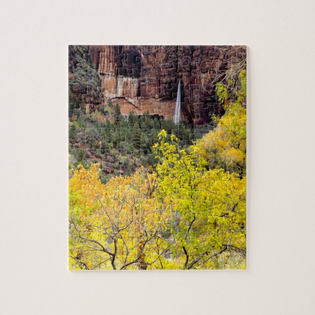 Ephemeral waterfall pours out of slot in cliff jigsaw puzzle (Vertical)