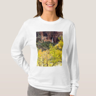 Ephemeral waterfall pours out of slot in cliff T-Shirt
