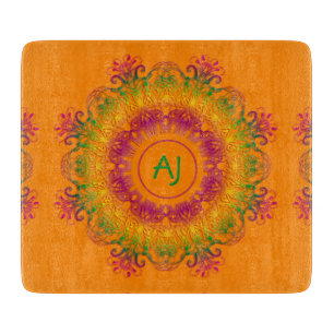 Ethnic Mandala Monogram.Orange background. Cutting Board
