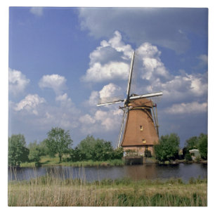 Europe, Netherlands, Kinerdijk. A windmill sits Tile