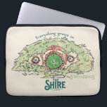 Everything Grows in THE SHIRE™ Laptop Sleeve<br><div class="desc">Bring a little piece of Middle-Earth™ to your everyday with this charming Lord of the Rings™ design inspired by the cozy hills of Hobbiton. Featuring a storybook-style hobbit hole with its iconic round green door tucked into a lush hillside, the artwork is paired with the beloved phrase, “Everything grows in...</div>