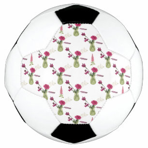 Exotisches Blumenarrangement im Glas Football