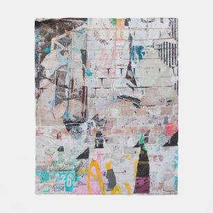 Exposed weathered brick wall with torn street post fleece blanket