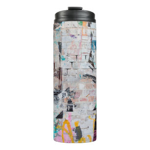 Exposed weathered brick wall with torn street post thermal tumbler