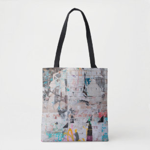 Exposed weathered brick wall with torn street post tote bag