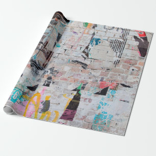 Exposed weathered brick wall with torn street post wrapping paper