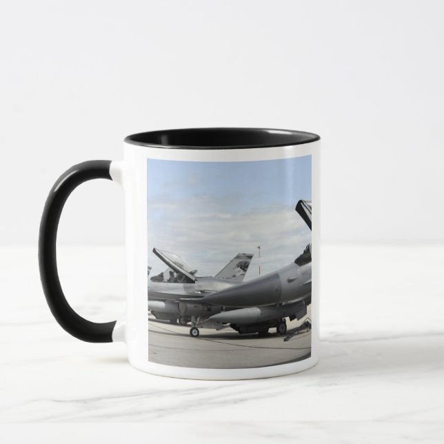 F-16 Fighting Falcons await to launch Mug (Left)