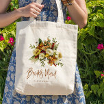Fall botanical bouquet bridesmaid name tote bag<br><div class="desc">Modern rustic bridesmaid tote bag gift featuring autumn fall rusty orange gold and ivory cream flowers with dried leaves and foliage and a whimsical chic typography script.             Personalise it with her name on the front side and with the wedding couple's names and date on the reverse.</div>