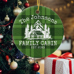 Family Cabin Green Plaid Themed Name Personalised Ceramic Tree Decoration<br><div class="desc">Ideal for family gatherings, reunions, or your mountain retreat, this product is designed with a charming green plaid background. It showcases a beautifully designed mountain scene with cabin surrounded by trees, personalised with your family name, the year established, and any additional details you prefer. An excellent choice for a thoughtful...</div>