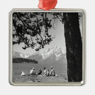 Family having picnic by lake mountains metal tree decoration