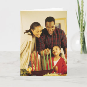 Family lighting the Kinara for Kwanzaa Holiday Card