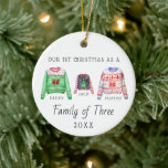 Family of Three | First Christmas Ornament<br><div class="desc">The perfect first Christmas keepsake for your family's first Christmas with your new baby. Our personalised Christmas ornaments feature charming watercolor ugly sweaters family, your family name and is also personalised with your photo on the back. Add your custom wording to this design by using the "Edit this design template"...</div>