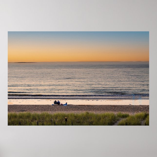 Family sitting on the beach at sunset poster (Front)
