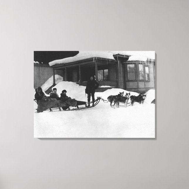 Family travelling by Dog Sled in Alaska Canvas Print (Front)