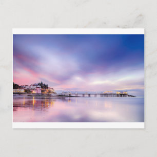 Famous Cromer pier in Norfolk England with pink su Postcard