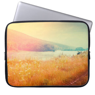 Fantastic foggy river with fresh grass in the sunl laptop sleeve
