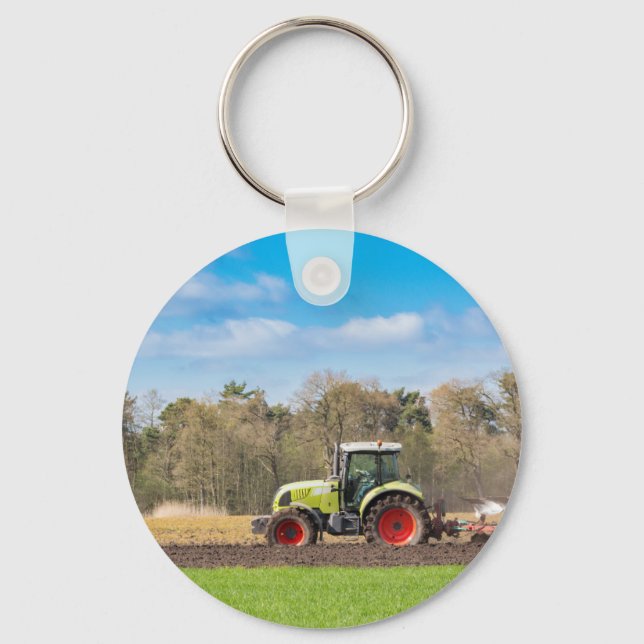 Farmer on tractor ploughing sandy soil in spring key ring (Front)