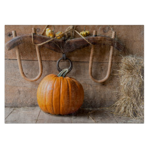 Farmers Museum. Pumpkin in barn with bale of hay Cutting Board