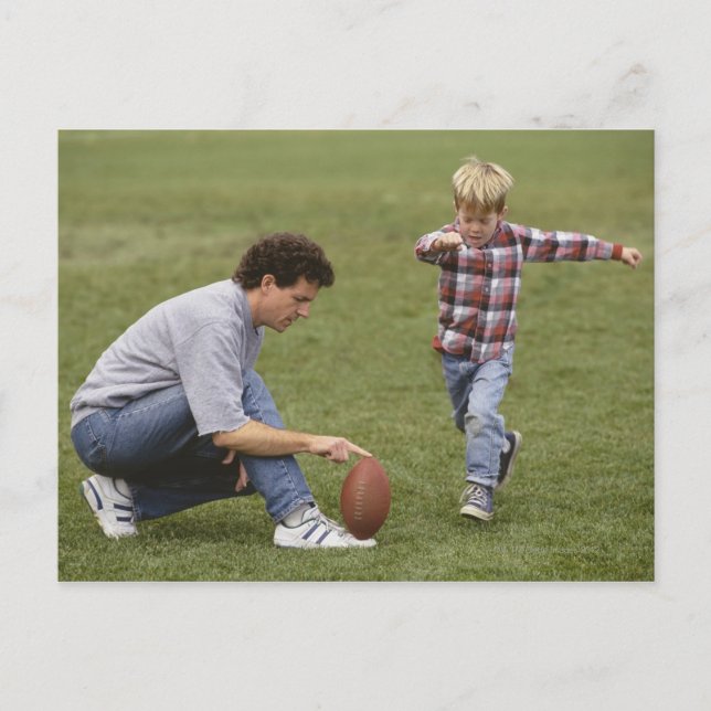 Father and son (4-6) playing American football Postcard (Front)
