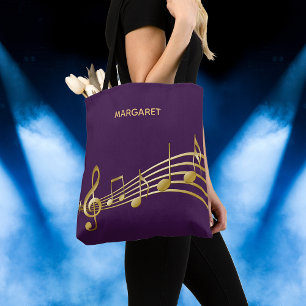 Faux gold music notes on a chic purple backdrop tote bag