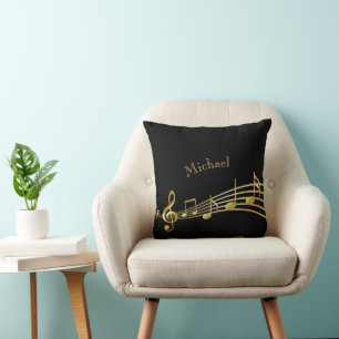 Faux gold music notes on black background cushion