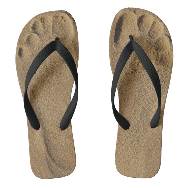 Feet in the sand flip flops (Footbed)