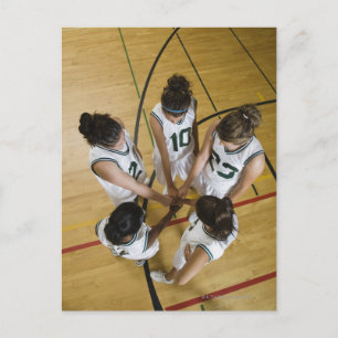 Female basketball team having group handshake, postcard