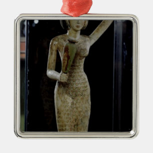 Female bearer of offerings carrying a water metal tree decoration
