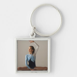 Female gymnast (12-13) performing splits key ring