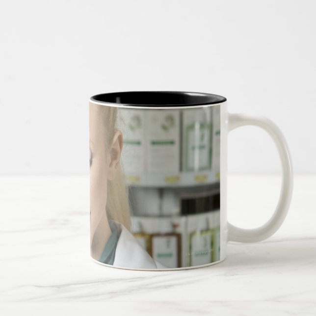 Female pharmacist looking at medicine in Two-Tone coffee mug (Right)