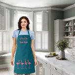 Festive Flamingos Personalised Dark Teal Apron<br><div class="desc">Flamingos on dark teal blue,  bib apron with pink text.  Use for a business or seaside kitchen.  Four flamingos at the top of the apron and four,  larger flamingos at the hemline.  They wear floral wreaths and stand among little blue sea stars.</div>
