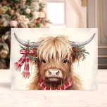 Festive Highland Cow with Plaid Scarf  Holiday Card<br><div class="desc">Celebrate the holiday season with our Festive Highland Cow with Plaid Scarf Holiday Card! This delightful card features a charming illustration of a highland cow adorned with a cosy plaid scarf and festive greenery, capturing the rustic and heartwarming spirit of Christmas. Perfect for sharing joyful wishes with friends and family,...</div>