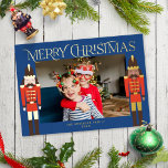 Festive Nutcracker Christmas Photo Blue Gold Foil Holiday Card<br><div class="desc">This festive holiday photo card features a horizontal photo on a dark blue background with two nutcrackers on each side standing guard, and the greeting "Merriest Christmas". The nutcrackers are dressed in red and dark brown and accented with gold foil. The greeting and your name are also in gold foil....</div>