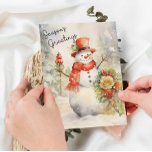 Festive Snowman Season's Greetings Holiday Card<br><div class="desc">Celebrate the joy of the holiday season with this charming greeting card featuring a festive snowman adorned with a red hat and scarf, surrounded by winter foliage. The message "Season's Greetings" adds a warm, classic touch, making it perfect for sending to loved ones. This versatile card is ideal for framing...</div>