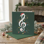 Festive Treble Clef Santa Hat Christmas Lights Holiday Card<br><div class="desc">Festive Treble Clef Santa Hat Christmas Lights Music Art features a white treble clef topped with a Santa hat and wrapped in colourful holiday lights. Tiny musical notes and gold swirls add movement and a cheerful seasonal feel. The dark green background gives the design a rich festive look. It is...</div>