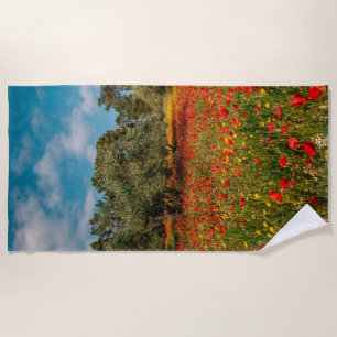 field with flowers and trees beach towel