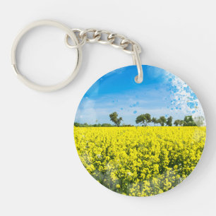 Field with yellow flowers and blue sky key ring