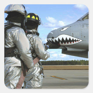 Firefighters deploy a fire hose during a drill square sticker