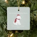 First Christmas Baby Polar Bear Blue Snow Ceramic Ornament<br><div class="desc">Illustration of a baby polar bear cub wearing a santa hat and matching scarf surrounded by snowflakes with a light blue background.  Text says,  "My first Christmas."  Personalise the name and year.</div>