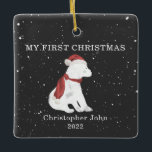 First Christmas Baby Polar Bear Dark Grey Snow Ceramic Ornament<br><div class="desc">Illustration of a baby polar bear cub wearing a santa hat and matching scarf surrounded by snowflakes with a dark grey background.  Text says,  "My first Christmas."  Personalise the name and year.</div>