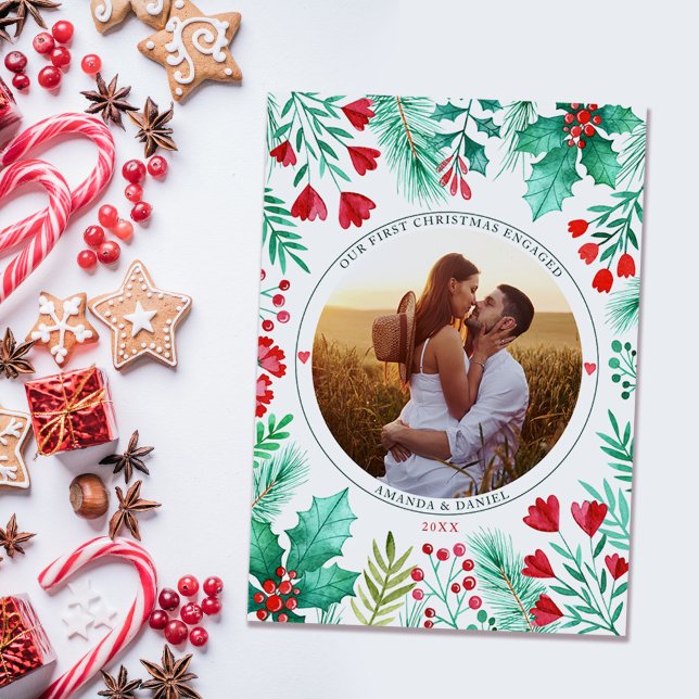 First Christmas Engaged Couple Photo Watercolor Holiday Card (Our First Christmas Engaged Watercolor Foliage Holiday Card)
