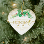 First Christmas Engaged Gold Glitter Holly Photo Ceramic Tree Decoration<br><div class="desc">For your first Christmas engaged this elegant holiday heart shaped ornament features a sprig of holly painted in watercolor accented by faux gold glitter. Below it reads in faux gold glitter script typography "Our First Christmas engaged" with your first names and year to personalise. The back of the ornament features...</div>