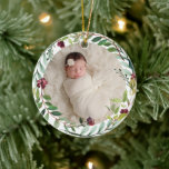 First Christmas Green Holiday Wreath Baby Photo Ceramic Tree Decoration<br><div class="desc">This elegant two-sided holiday photo keepsake ornament features a newborn photo of your baby girl framed by a floral watercolor holiday greenery wreath. The back of the ornament includes "First Christmas" wording with custom text that can be personalised with the baby's full name and the year of their birth. Includes...</div>