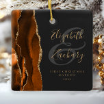 First Christmas Married Burnt Orange Agate Gold Ceramic Ornament<br><div class="desc">This elegant modern ornament features a burnt orange watercolor agate design trimmed with faux gold glitter. Easily customise the gold-coloured text on an off-black background, with the names of the bride and groom in whimsical handwriting calligraphy over a large grey ampersand. The words "First Christmas Married" appear in serif font...</div>