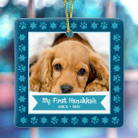 First Hanukkah Pet Puppy Photo Paws Stars Navy Ceramic Ornament<br><div class="desc">“My First Hanukkah.” Celebrate your new pet’s arrival this past year! A turquoise blue banner with your pet’s name and year in whimsical white typography overlays your puppy or kitten’s custom photo. A playful border of turquoise blue paw prints and Stars of David against navy blue surrounds it. Feel the...</div>