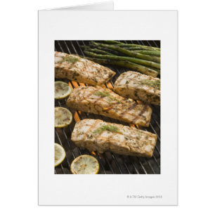 Fish and asparagus cooking on grill